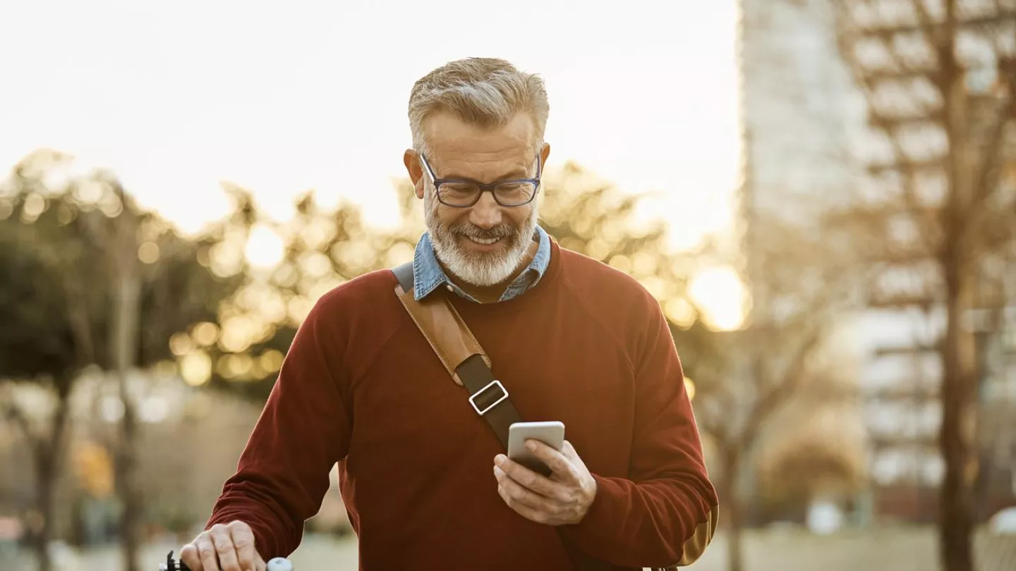 Man with a bike checking his smartphone