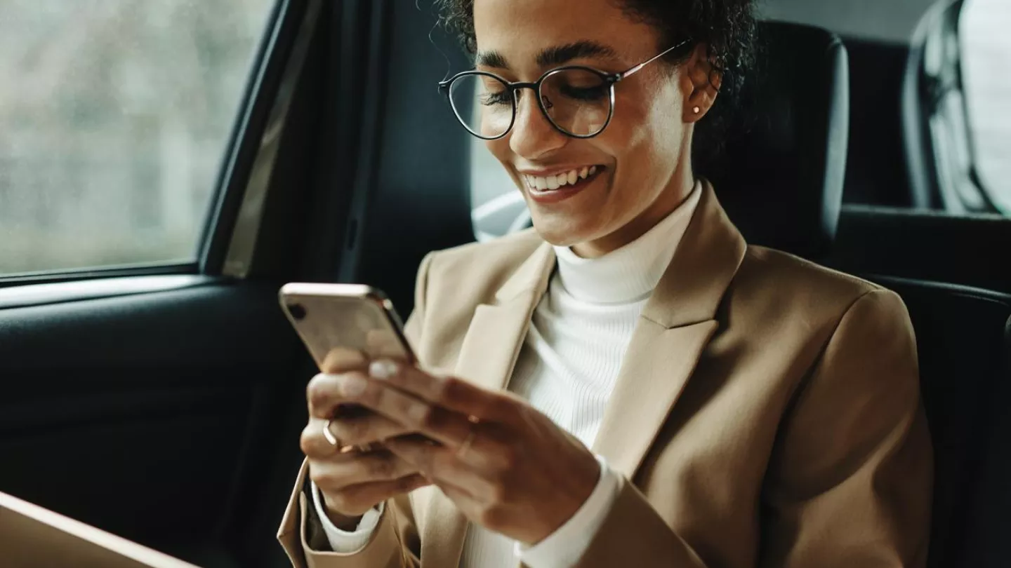 A woman applying for a job checks her phone