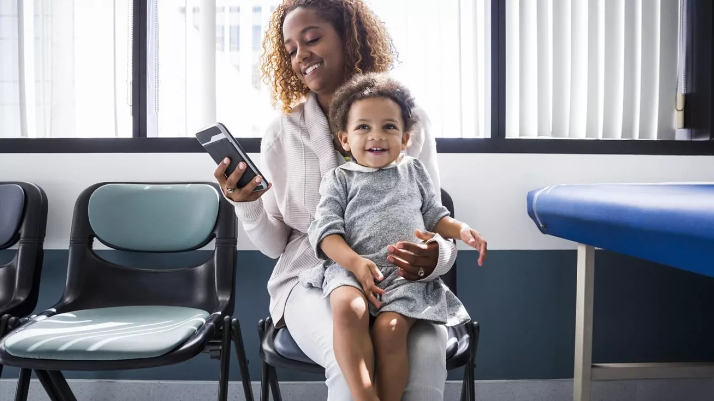 Woman with her child checking her phone