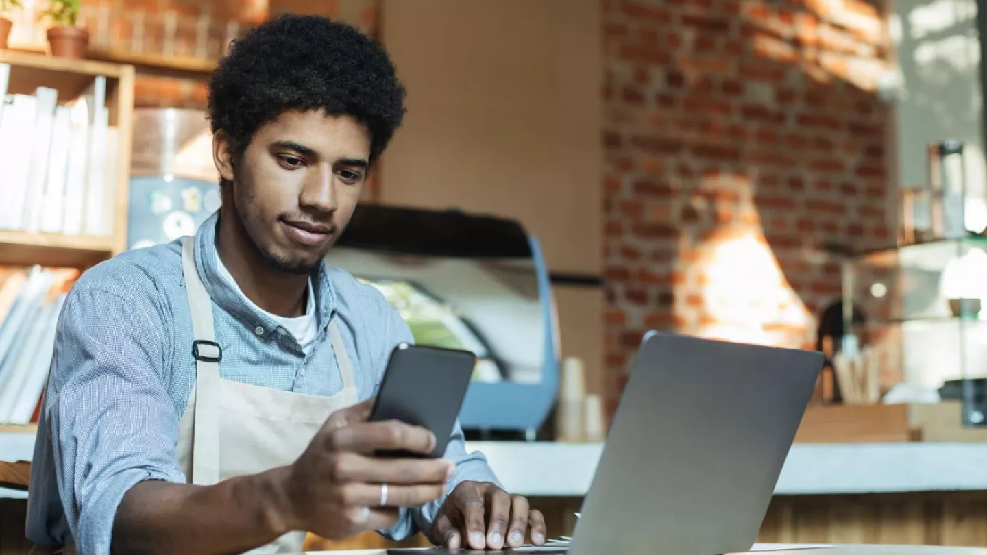 Small business owner looking at a smartphone