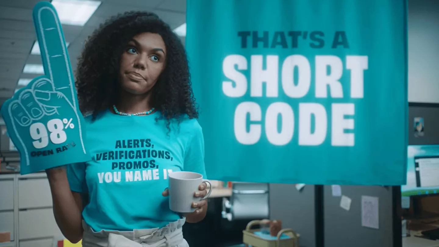 Image of a woman in front of "That's a Short Code" backdrop